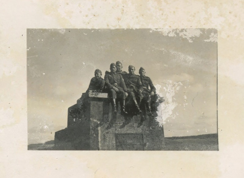 A group of people sitting on top of a building.