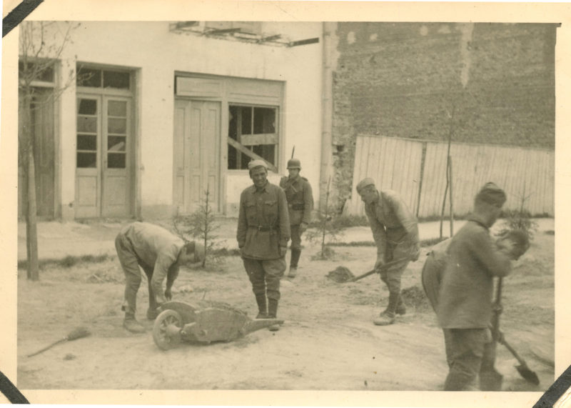 A group of men working on the ground.