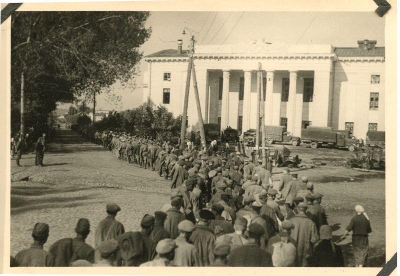 A group of people standing in front of a building.