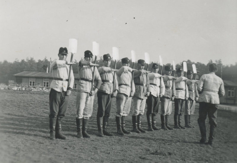 A group of men in uniform holding baseball bats.