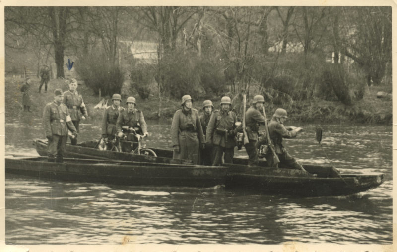 A group of men in a boat on the water.