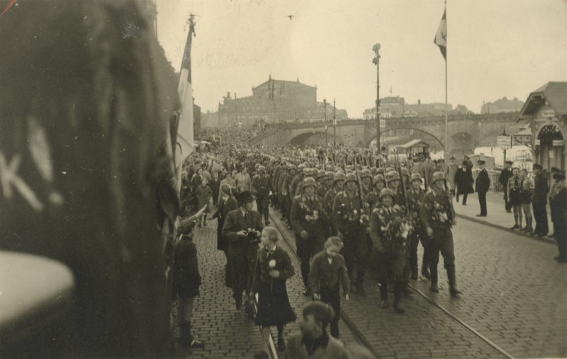 A large group of people marching down the street.