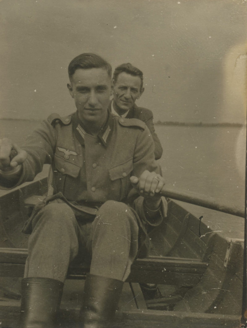 Two men in a boat on the water.