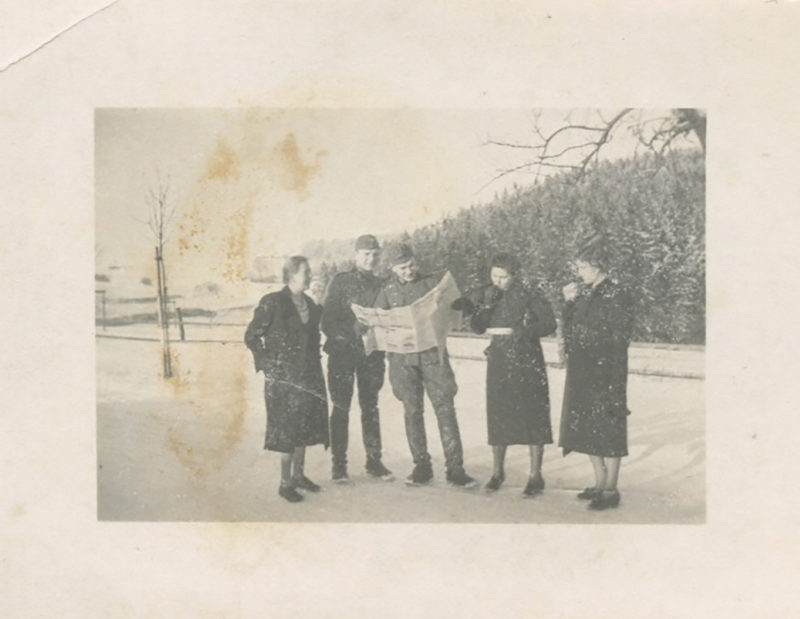 A group of people standing in the snow.