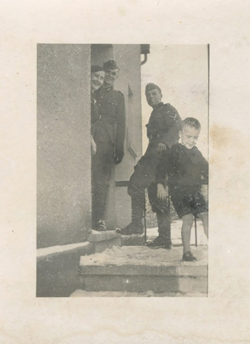 A group of men standing on steps in front of a building.