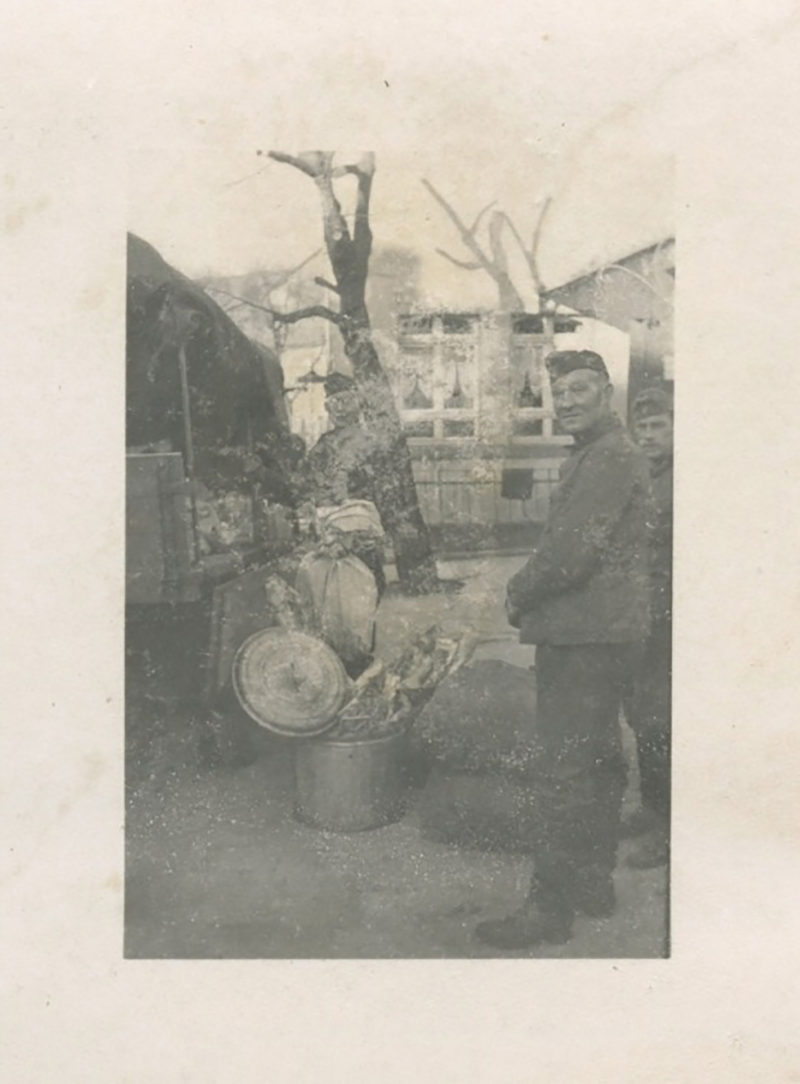 A man standing next to some food on the ground.