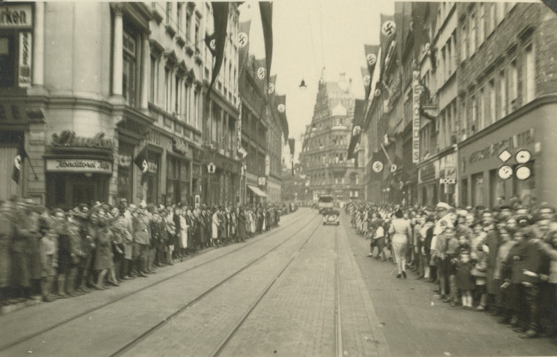 A crowd of people walking down the street.