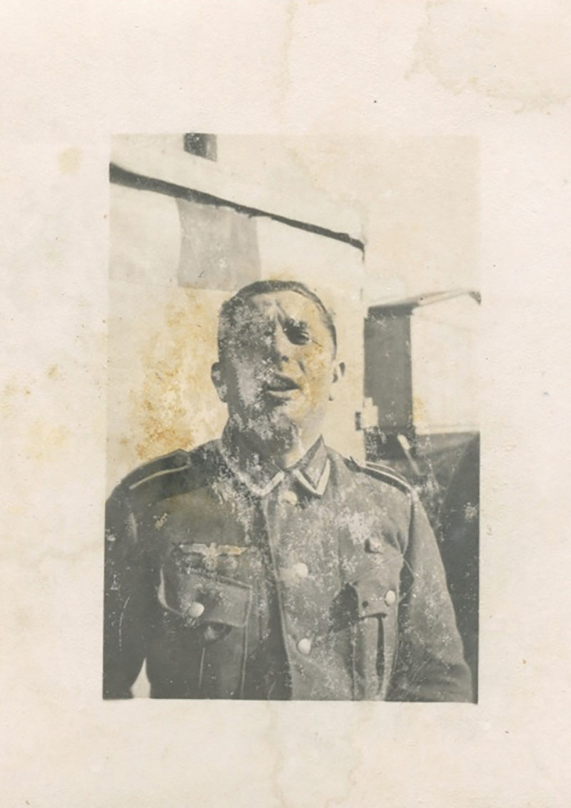 A man in military uniform with blood on his face.