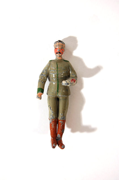 A toy soldier in uniform with a gun.
