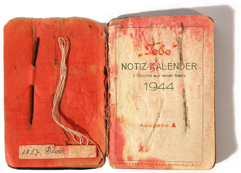 A book with an old cover and some writing.