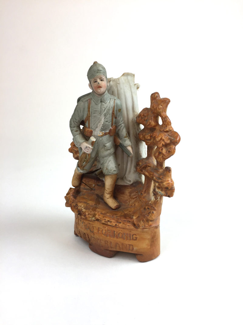 A statue of a man holding a sword and a cane.