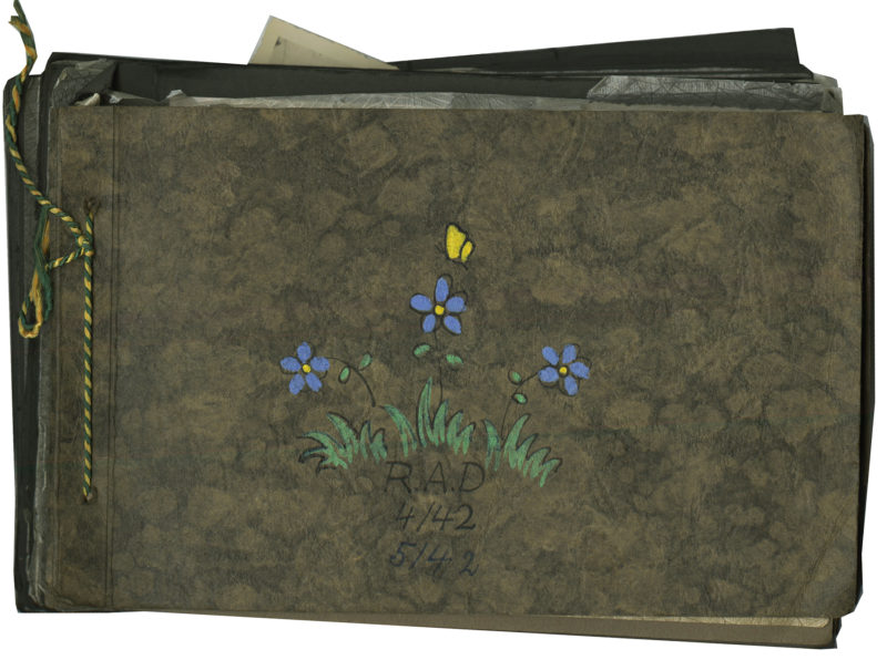 A brown bag with blue flowers and a yellow butterfly.