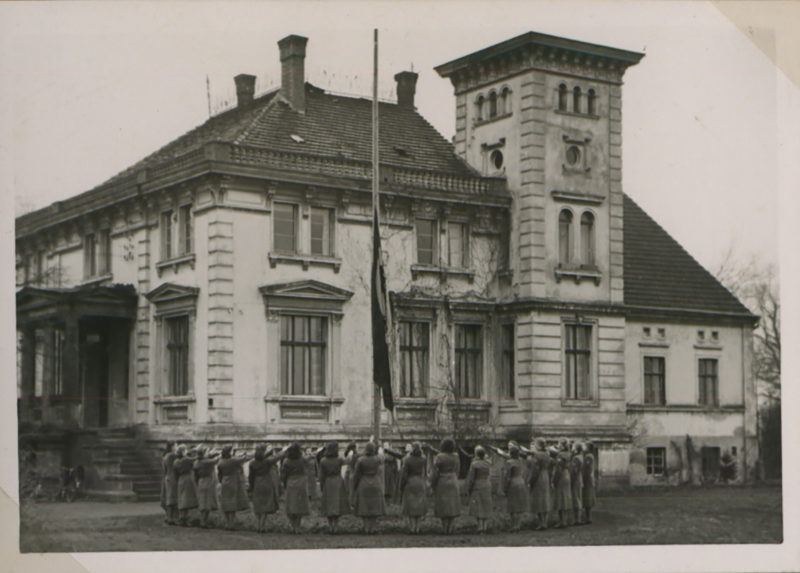 A group of people standing in front of a building.