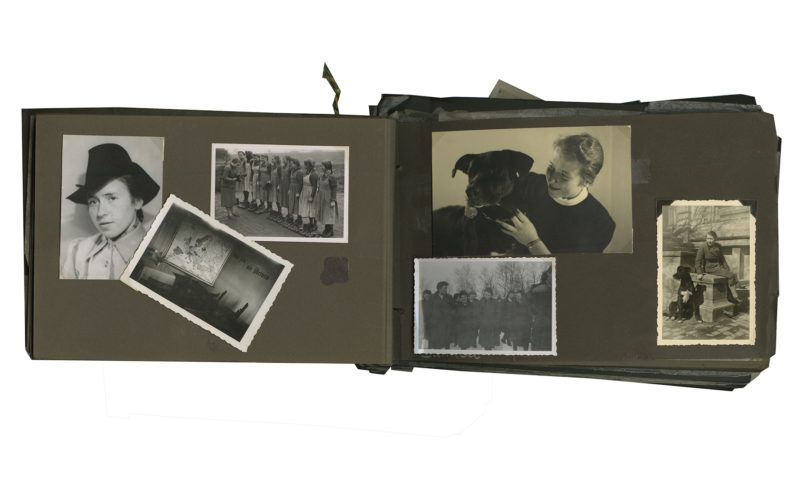 A photo album with pictures of people and dogs.