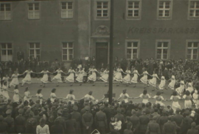 A group of people in front of a building.