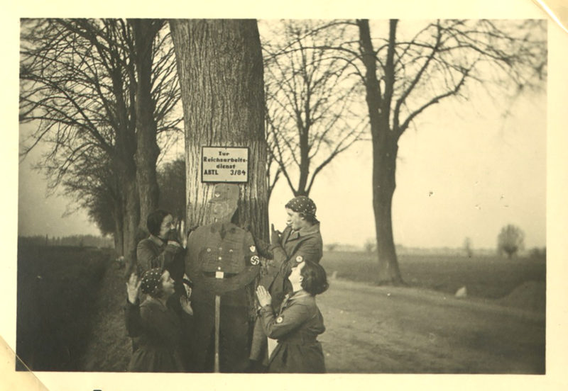 A group of people standing around a tree.