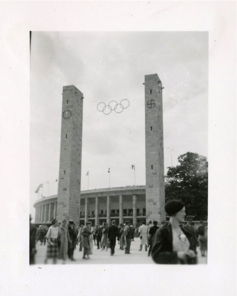 A crowd of people standing around a building.