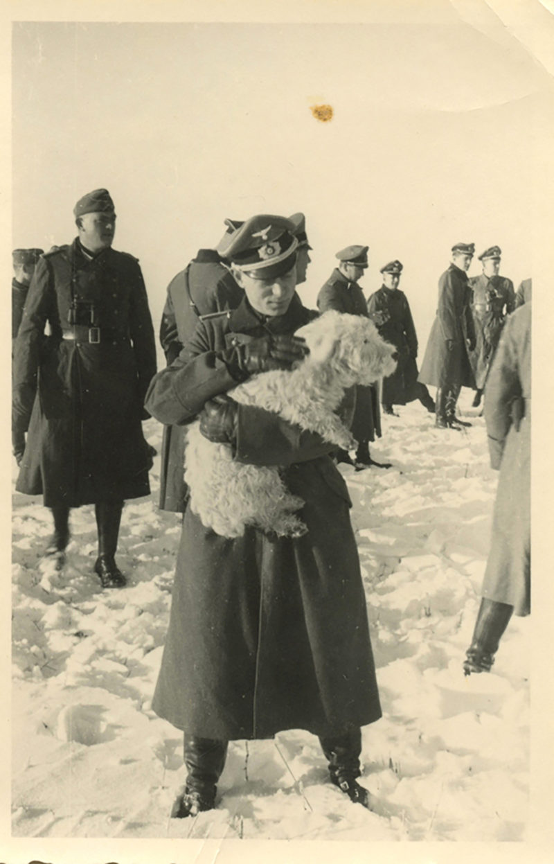 A woman holding a sheep in her arms.