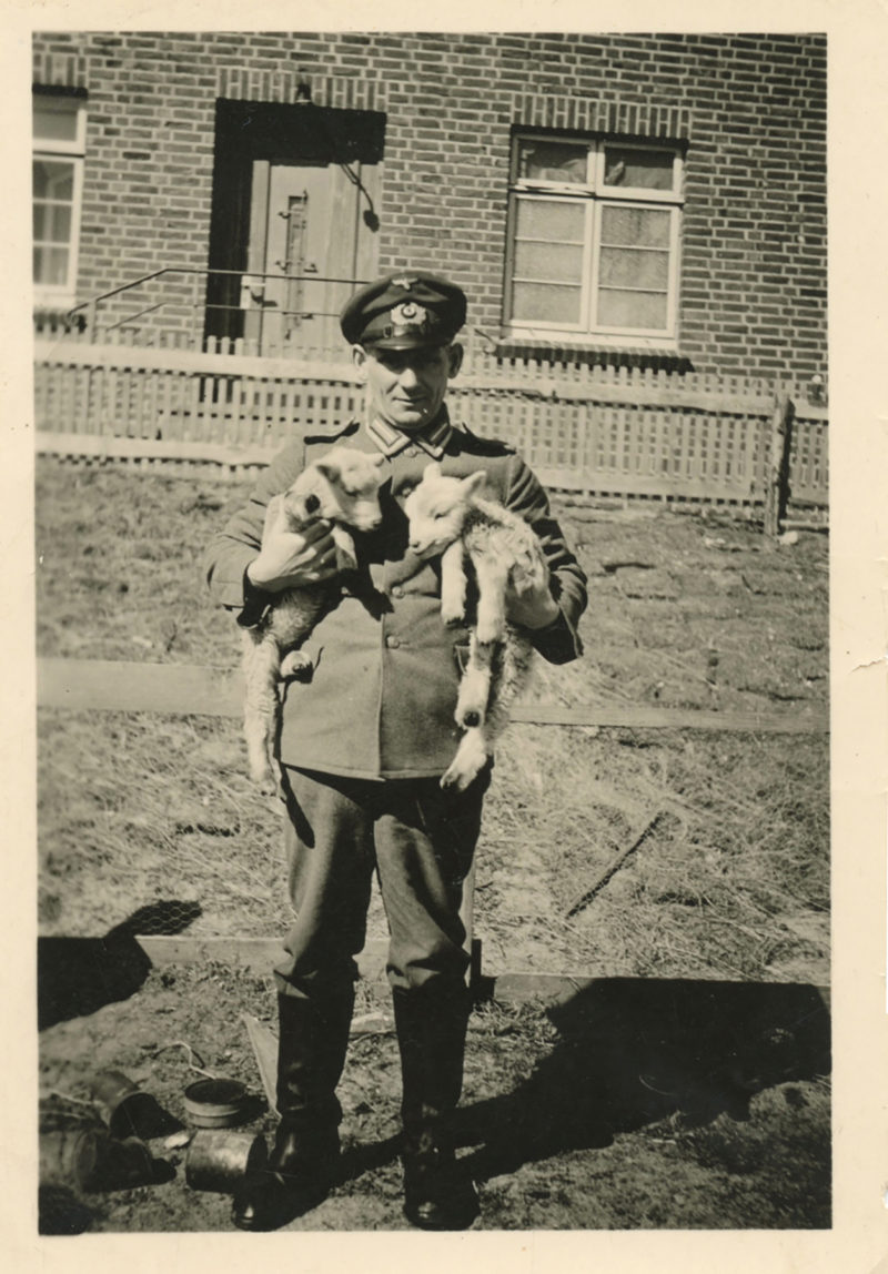 A man in uniform standing on the ground.
