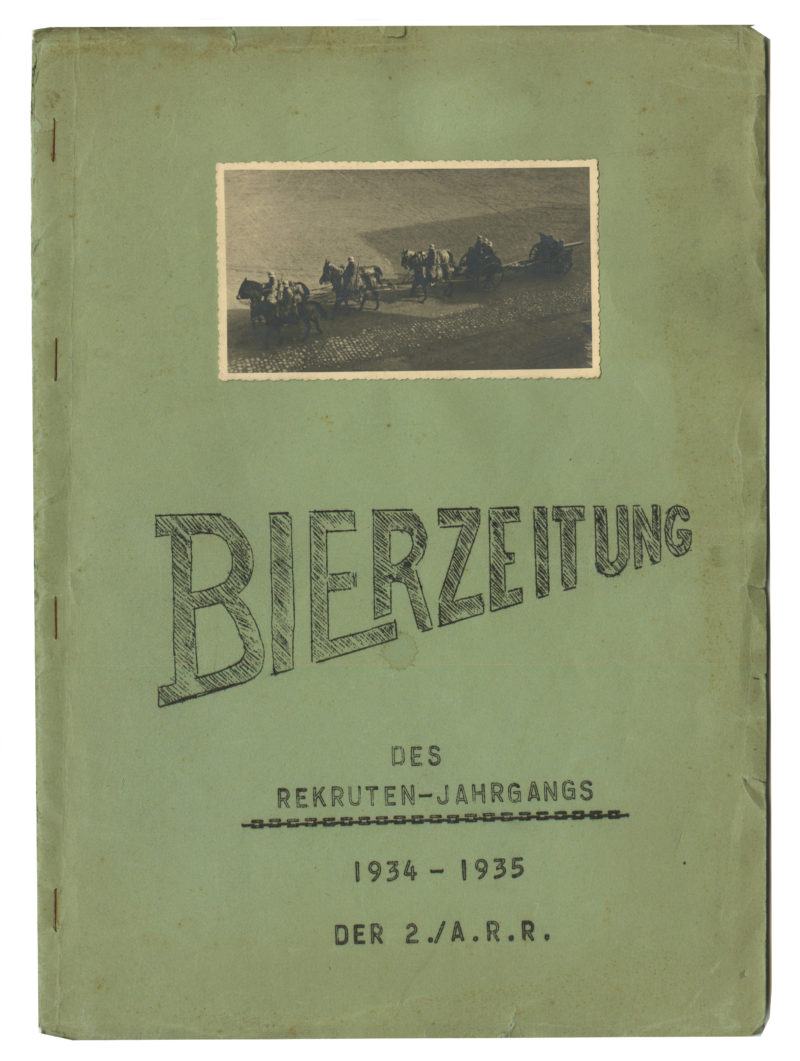 A green book with an old photo of people on horseback.